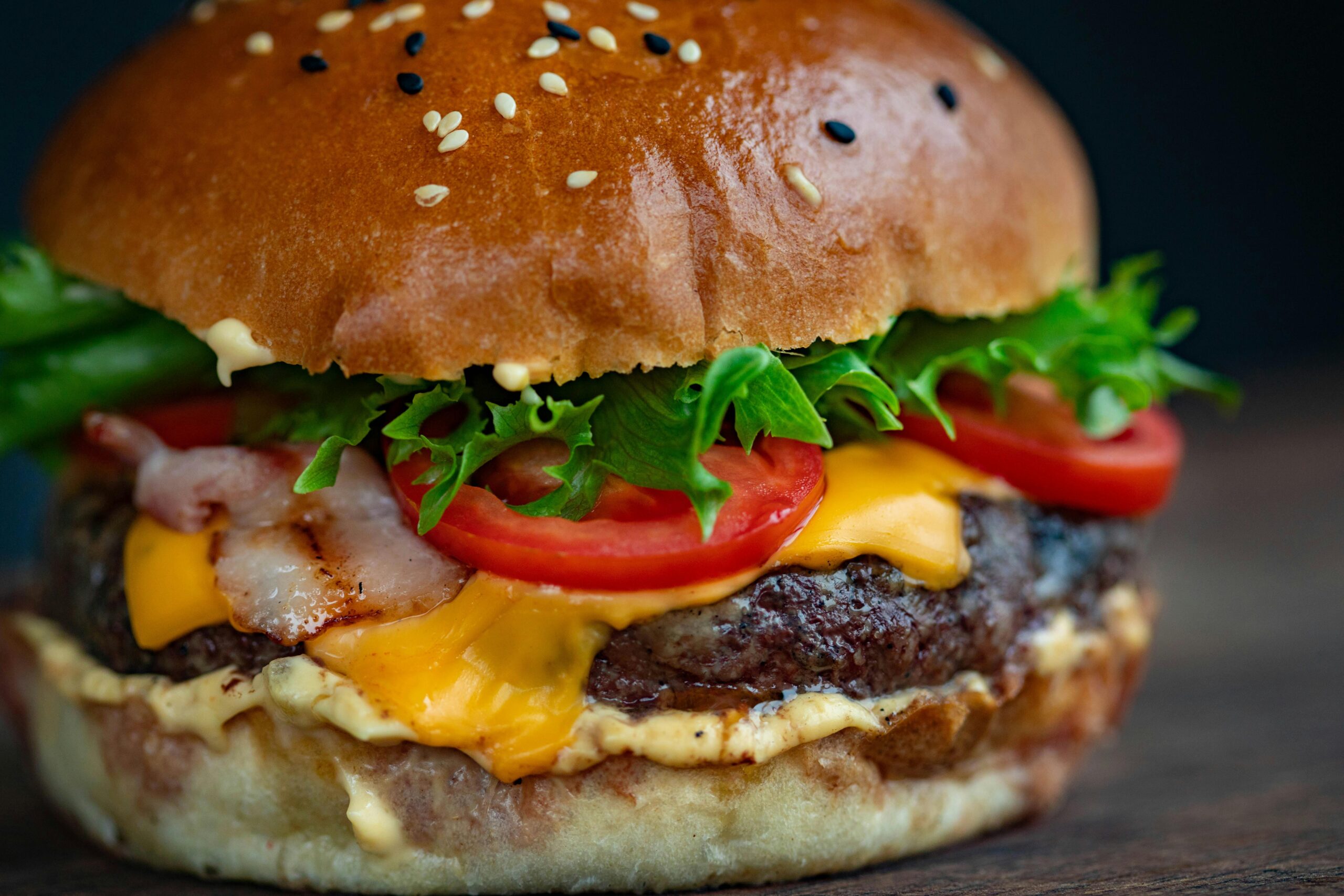 pexels-photo-1639557-1639557 Juicy cheeseburger with bacon, lettuce, tomato, and sesame seed bun.